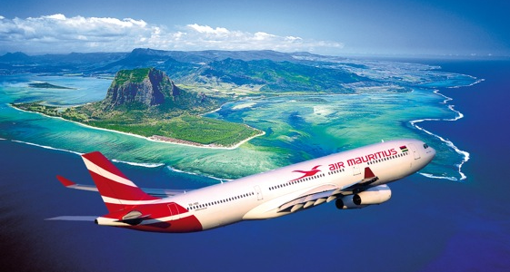 Airplane flying over turquoise waters with a map.