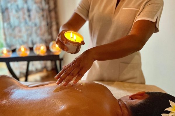 Guests enjoying paddleboarding in the lagoon at Royal Palm Beachcomber Luxury.