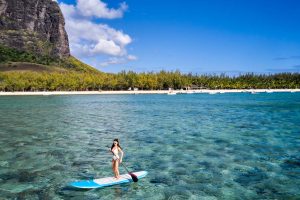 Paddleboarding riding the waves in the turquoise lagoon
