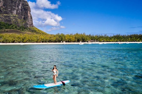 Paddleboarding riding the waves in the turquoise lagoon