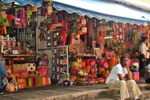 Handwoven baskets, wooden carvings, and textiles for sale at Port Louis Market