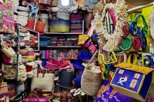 Handwoven baskets, wooden carvings, and textiles for sale at Port Louis Market