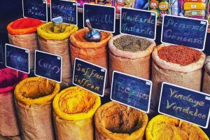 Variety of spices including turmeric, cinnamon, and masala blends at the market