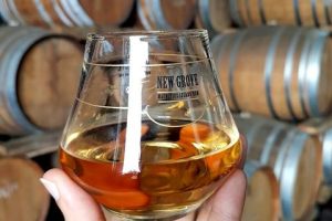 Oak barrels stacked for aging New Grove’s premium rums.