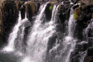 Waterfall cascading over basalt formations