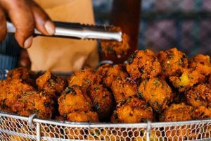 A close-up of crispy gateaux piments on a serving plate.