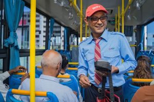 Mauritian bus on a coastal road with locals